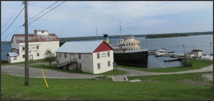 Manitoulin Roller Mills and Burn's Wharf were built in 1883 and contain some of the original agricultural machinery. Adjacent to the mill is its warehouse now used as a summer theater and for pictorial display of the area's history.